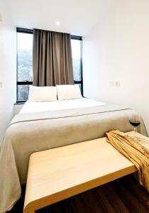 a bedroom with a large bed and a window at Capsula Hotel Sao Paulo - Paulista in Sao Paulo