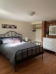 a bedroom with a bed and a dresser in it at Downtown one bedroom/Historic Bauer Terrace in Halifax