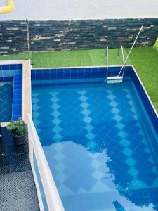 a swimming pool with a blue tiled at Casa con piscina in El Colegio