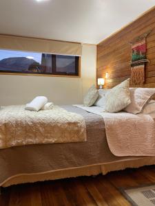 een slaapkamer met een groot bed en een raam bij Apartamento Coyhaique in Coihaique