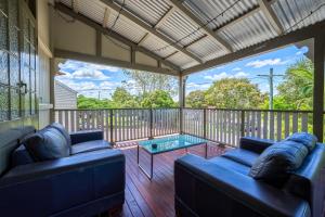 a screened in porch with two couches and a table at Yandina Hotel in Yandina