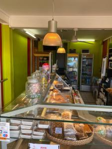 a display case in a bakery with many pastries at La résidence du sportif Bernard in Anse-Bertrand