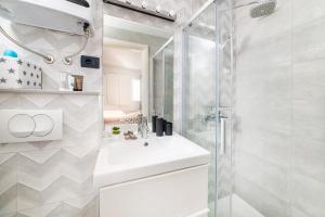 a bathroom with a sink and a shower at Amare Apartments in Bobovišća