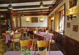 a restaurant with purple tables and chairs in a room at Gasthof Rössle in Bad Dürrheim
