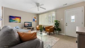 a living room with a couch and a tv at 204 E Syracuse Ave in Wildwood Crest