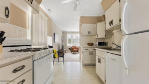 a kitchen with white cabinets and a refrigerator at 204 E Syracuse Ave in Wildwood Crest