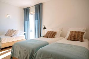 מיטה או מיטות בחדר ב-Casa da Barra