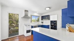 a kitchen with blue and white appliances and a window at Family Friendly House With Pool & Aircon in Woorim