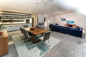 a living room with a table and a couch at Waves 6 on Hamilton Island by HIHA in Hamilton Island