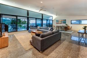 a living room with a couch and a table at Waves 6 on Hamilton Island by HIHA in Hamilton Island