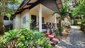 a house with a porch and stairs leading to it at Pattaya Garden Resort in North Pattaya