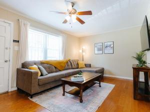 a living room with a couch and a ceiling fan at Centrally Located 3BR Overton Square Fast WiFi Free Parking Yes Pets in Memphis