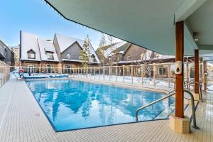 a large swimming pool with snow on the ground at Mystic Getaway in Canmore