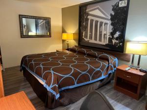 a hotel room with a bed and a mirror at Raceway inn in Martinsville