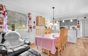 a kitchen and dining room with a table and chairs at Gorgeous Home In Ansager With Wifi in Ansager