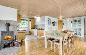 a kitchen and dining room with a table and a stove at Holiday Home Hejls 28 in Hejls +18 photos