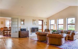 a large living room with couches and a tv at Cozy Home In Jgerspris With Kitchen in Jægerspris