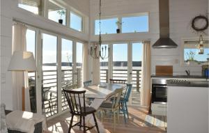 a kitchen and dining room with a table and chairs at Stunning Home In motfors With Lake View in Åmotsfors