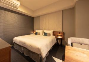 a hotel room with a bed and a table at Tokyu Stay Sapporo Odori in Sapporo