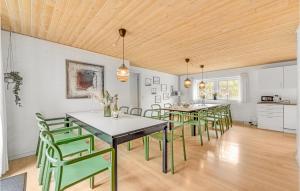 HusbyにあるAwesome Home In Ulfborg With Saunaのダイニングルーム(テーブル、緑の椅子付)