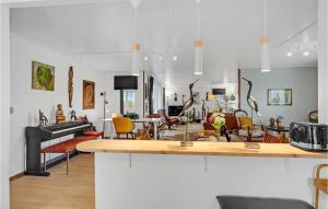 een keuken en een woonkamer met een aanrecht en stoelen bij 3 Bedroom Nice Home In Tranekr in Tranekær