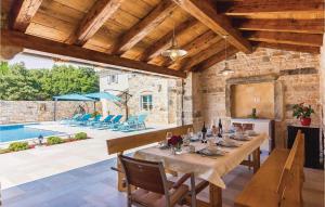 a dining room with a table and a pool at Holiday Home Vodnjan With Fireplace I in Vodnjan