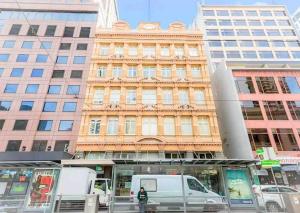 a white van parked in front of a building at Melbourne City Central Apartment - 296 in Melbourne