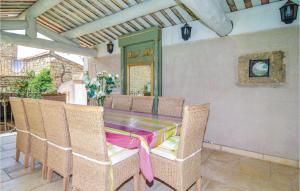 a dining room with a table and chairs at Awesome Home In Orgon With 6 Bedrooms, Wifi And Outdoor Swimming Pool in Orgon