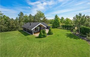 a small house on a large lawn with trees at Amazing Home In Tarm With Wifi in Hemmet
