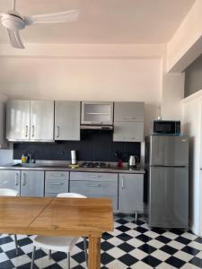 a kitchen with white cabinets and a wooden table at 704 vista casco antiguo y nuevo in Cartagena de Indias