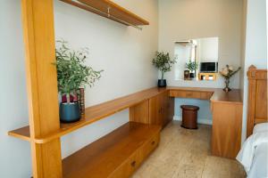 a room with a wooden shelf and plants on the wall at The Vintage Hotel KhaoYai in Nong Nam Daeng