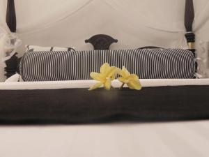 two yellow flowers sitting on top of a bed at Amanda Beach Villas in Unawatuna