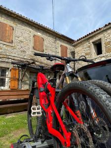 a bike sitting on the back of a car at Pri kovačih, Istra autentica in Movraž