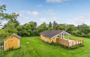 een tiny house in a field with a deck bij Gorgeous Home In Hurup Thy With Wifi in Heltborg
