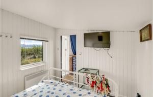 1 dormitorio con 1 cama y TV en la pared en 1 Bedroom Beautiful Home In Bandholm, en Bandholm