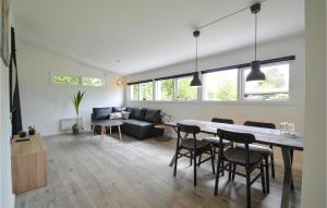 a dining room and living room with a table and chairs at Amazing Home In Kge With Kitchen in Strøby Egede
