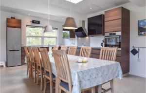 a kitchen and dining room with a table and chairs at 3 Bedroom Nice Home In Tranekr in Lohals