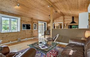 a living room with a couch and a table at Nice Home In Ebeltoft With 4 Bedrooms in Ebeltoft
