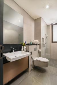 a bathroom with a sink and a toilet at 8 Kia Peng Residences by Times 8 in Kuala Lumpur