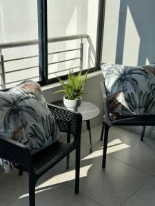 a balcony with two chairs and a table with a plant at M Luxury Home In Irene Centurion-No Blackouts in Centurion