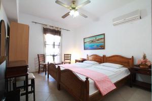 a bedroom with a bed and a table and chairs at Traditional Apartments Alexandra in Meyisti