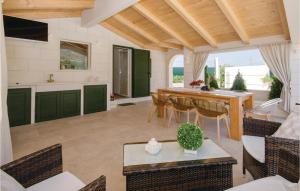 a kitchen and dining room with a table and chairs at Beautiful Home In Seget Donji With Heated Swimming Pool in Trogir