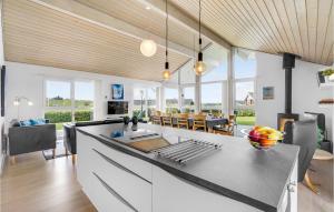 a kitchen and living room with a table and chairs at Holiday Home Kildebakken Vinderup V in Vinderup +20 photos