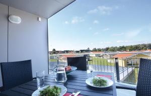 a table with two plates of food on a balcony at Appartement Seestern E in Schönhagen