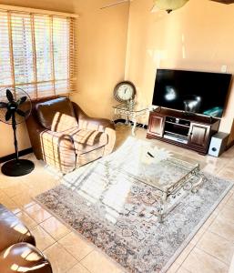 a living room with a couch and a tv at 2 Bed Apartment at the Hideaway in St Mary