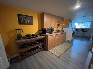 a kitchen with yellow walls and a counter with wine bottles at A Gem in the Emerald City: For Business and Travel in Seattle +13 photos