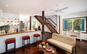 a living room with a couch and two stools at The Elephant in Siem Reap