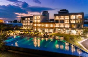 a hotel with a swimming pool in front of a building at The Grand Sumorum in Seogwipo