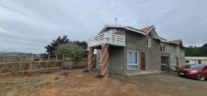 a house being built with a chimney on top at Casa playa Pullay in Pullay