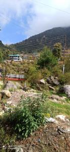 a view of a hill with a train on it at Mountain and Moon, Dharamkot in Dharamshala